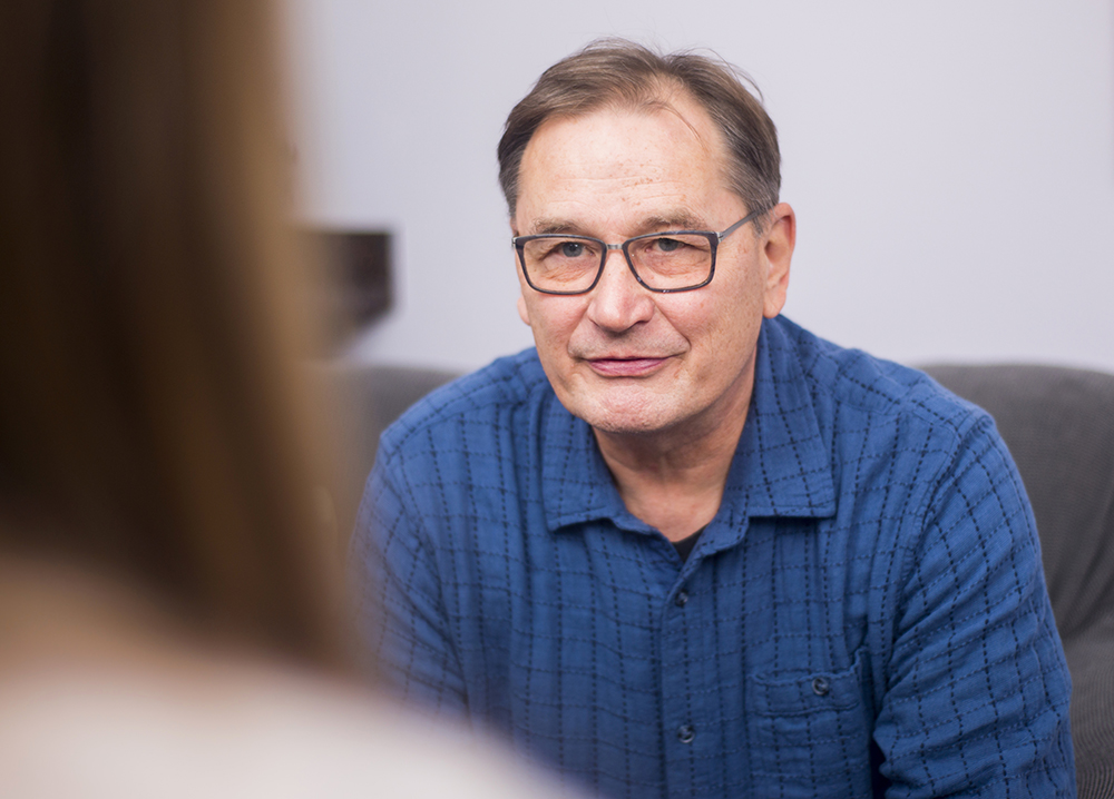 Image of a counselor at Interplay Counseling providing therapy to an older male individual in Coralville, Iowa